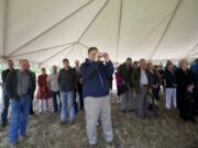 A crowd listens to Washington Gov.