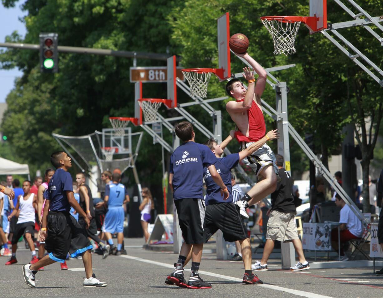 Photos by Steve Dipaola for the Columbian
The Hoops on the River three-on-three basketball tournament returned to Vancouver on Saturday with games on the streets around Esther Short Park.