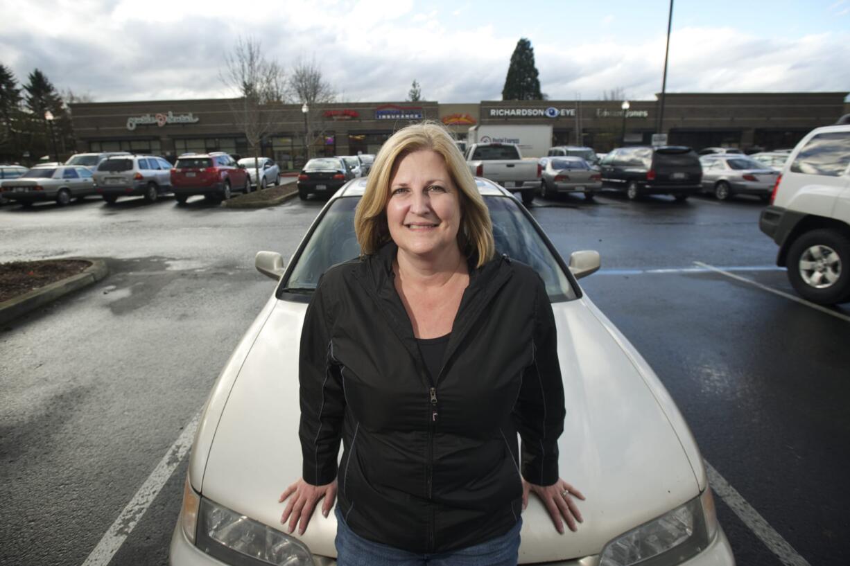 Rhonda Ouchida of Battle Ground stands in front of her 1995 Honda Accord.