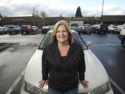 Rhonda Ouchida of Battle Ground stands in front of her 1995 Honda Accord.