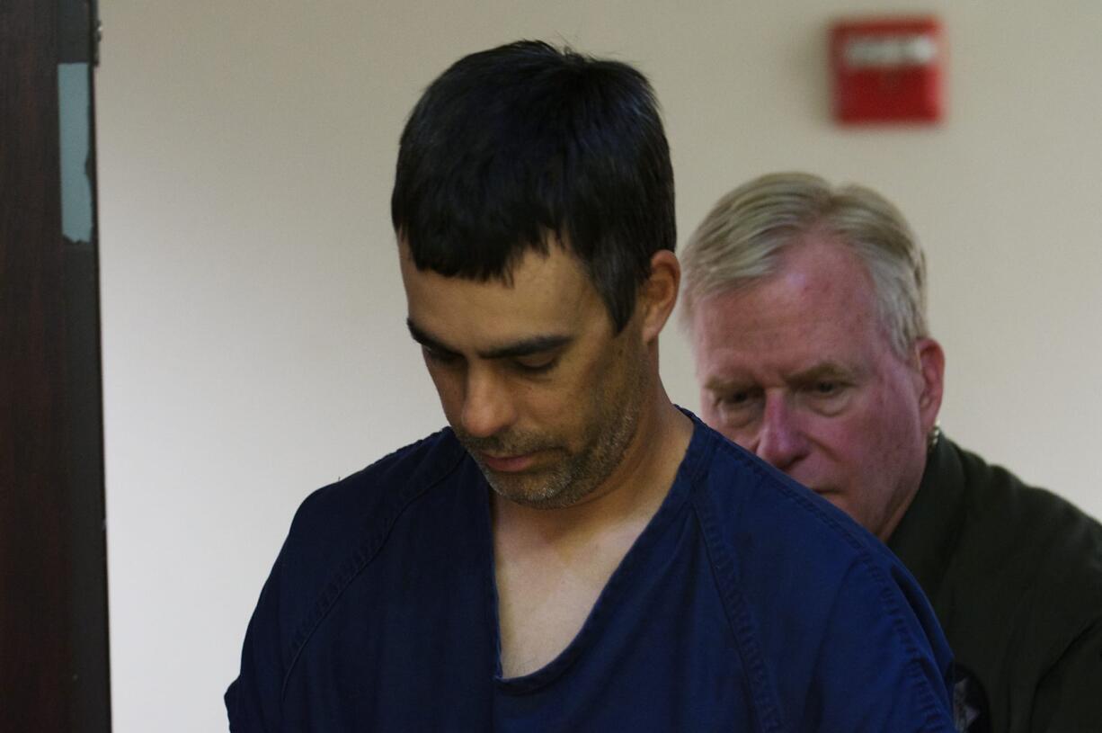 Skyview High School teacher Eric Estes, left, is escorted back to jail after appearing in Clark County District Court on June 12.