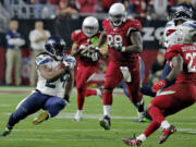 Seattle Seahawks running back Marshawn Lynch (24) cuts back during his 79-yard touchdown run against the Arizona Cardinals during the fourth quarter Sunday, Dec.