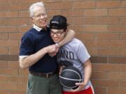 Jamie Stratton, left, shares a light-hearted squeeze with David Hinds, his &quot;little brother,&quot; during a break in shooting hoops at Fisher's Landing Elementary School on a recent Sunday afternoon.