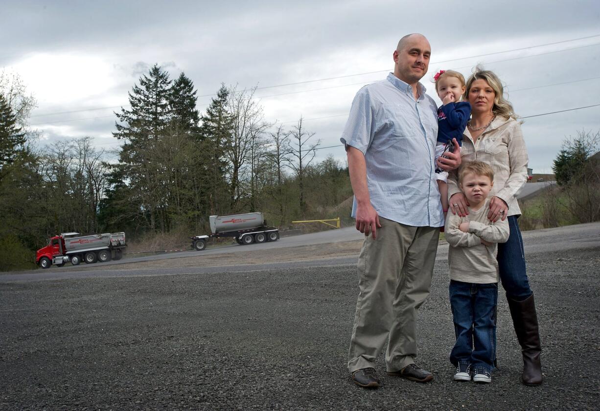 Tyler and Wendy McCullough and their children, Colton, 5, and Harley, 2, stand near the entrance to the J.L. Storedahl &amp; Sons quarry on Livingston Mountain.