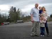 Tyler and Wendy McCullough and their children, Colton, 5, and Harley, 2, stand near the entrance to the J.L. Storedahl &amp; Sons quarry on Livingston Mountain.