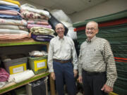 Pastor Jim Stender (L) and volunteer Denny Scott show a supply of bedding to be used in housing the needy this winter at Saint Andrew Lutheran Church in Vancouver Thursday September 16, 2015. The faith community aims to impact the affordable housing crisis.