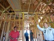 Clark County Fire District 6 Assistant Chief Shawn Newberry, right, points out modern fire safety features Thursday at the ArdenWood Station apartment complex in Hazel Dell.