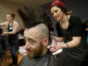 Jeff Roberson, 27, who declared himself &quot;a punk rocker through and through,&quot; receives a fresh mohawk Thursday from hairstylist Sarah Warman of the J.C.