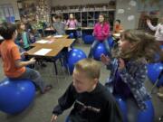 Alice Yang's fourth-grade students at Cape Horn-Skye Elementary School in Washougal bounce on stability balls while singing &quot;Nifty Fifty United States.&quot; Yang has incorporated the stability balls into her curriculum.