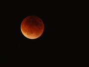 The lunar eclipse is seen from Hazel Dell on Sunday night. It was the first time since 1982 that the eclipse, known as a blood moon, appeared while the moon was as close as it gets to the earth this year.