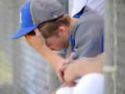 In this photo taken Tuesday, May 13, 2014, Rochester High School pitcher Dylan Fosnacht rests between the 13th and 14th inning of a District IV 1A baseball tournament first-round game against La Center, at Rochester High School in Rochester, Wash. Fosnacht threw 194 pitches as he took a shutout into the 15th inning. His team beat La Center 1-0 in 17 innings.