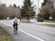 A bicyclist rides in a bike lane on MacArthur Boulevard in 2011. Three years later, bike advocates question why plans for Vancouver's downtown waterfront development don't include bike lanes.