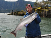 Guide Shane Magnuson poses with a spring chinook caught at the mouth of Wind River in Skamania County.