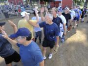 Judge Roger Bennett, center, and other members of his team congratulate their opposition as the &quot;old lawyers&quot; beat the &quot;young Lawyers&quot; in a softball game in Brush Prairie Wa., Sunday Sept 13, 2015.