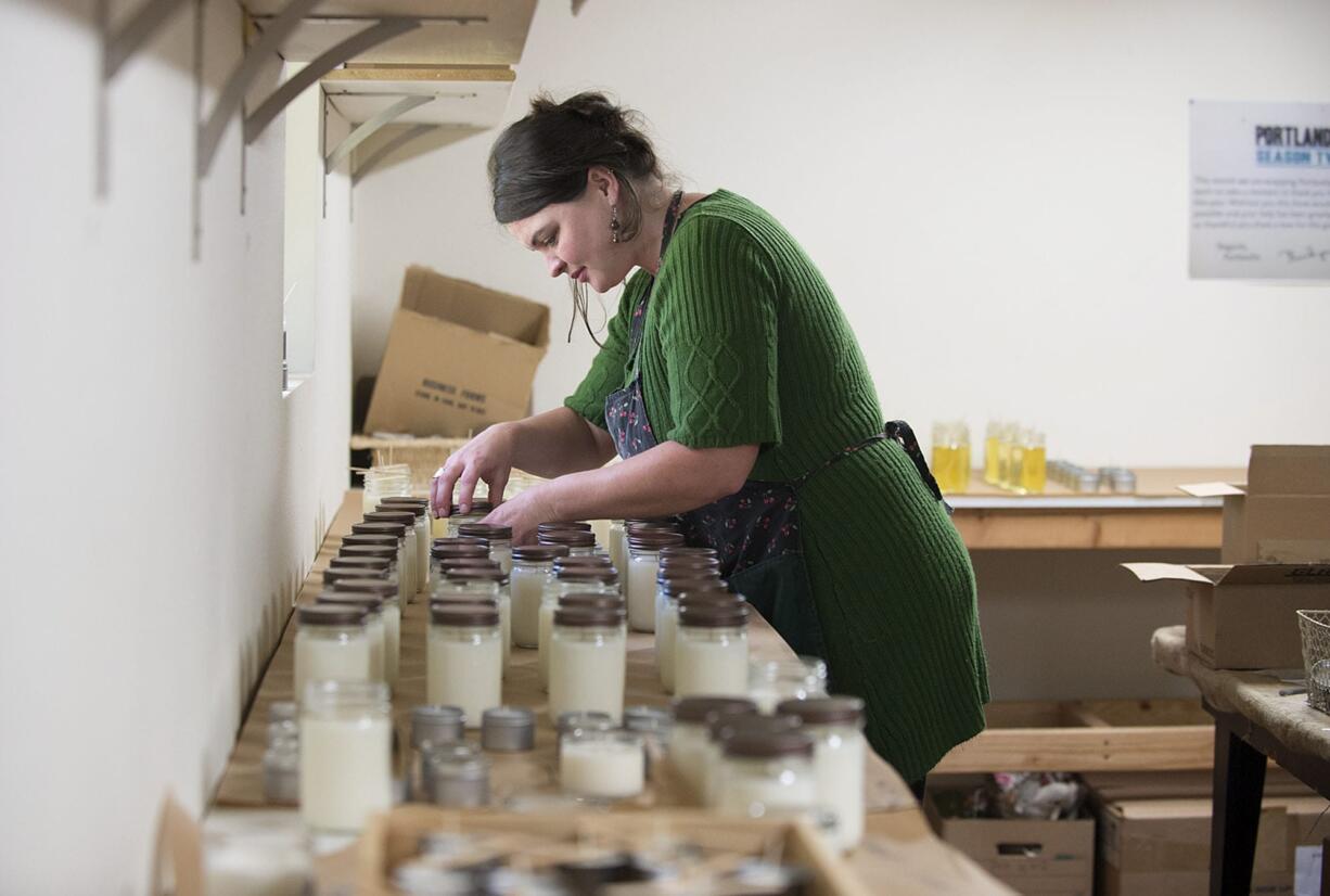 Amy Vance of Vance Family Soy Candles prepares a selection of Vanilla Spice candles in her Vancouver home studio Thursday.