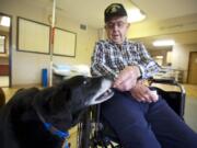 Oswald Kaul, 92, of Vancouver feeds Luke, a therapy dog at Fort Vancouver Convalescent Center.