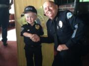 Battle Ground: Battle Ground Police Chief Bob Richardson shakes hands with honorary Police Chief Chase Getch, an 8-year-old boy with achondroplasia, a form of dwarfism.