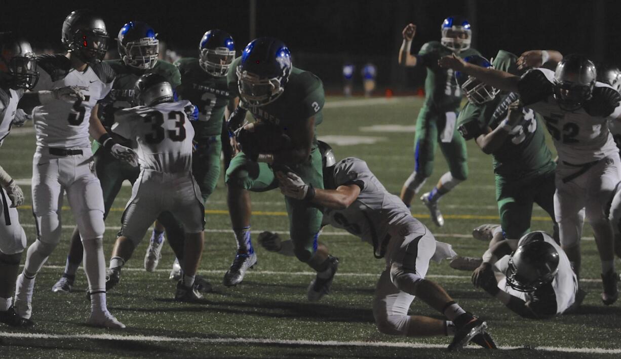 Mountain View's Preston Jones (#2) scores a touchdown against Union's Keithen Shepard (#3) during a high school football game in Vancouver Wa., Friday Sept 18, 2015.