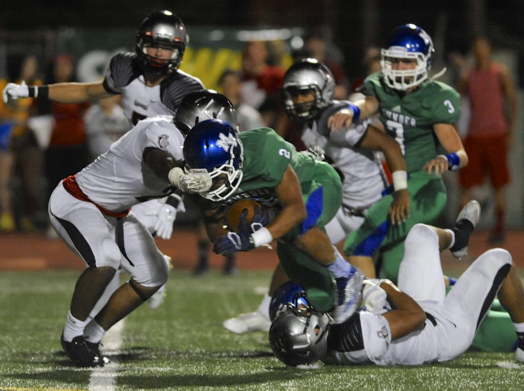 Union's Rey Green, at left, defends against Mountain View's Preston Jones (#2) during a high school football game in Vancouver Wa., Friday Sept 18, 2015.