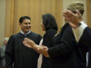 Bernard Veljacic looks at his wife, Pamela, after he is sworn in as Clark County's newest Superior Court judge Friday.