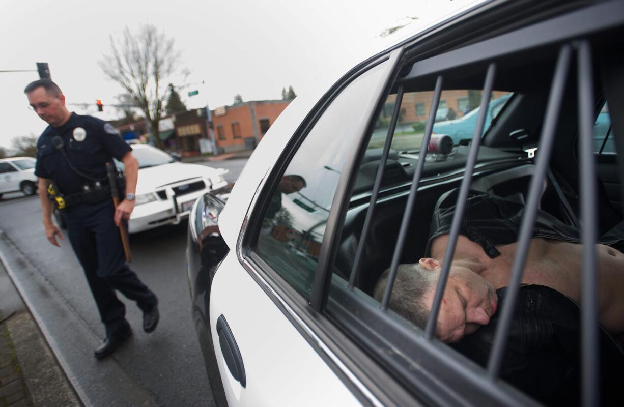 Police take a man in to custody after a crash ended a high speed pursuit in Uptown Village on Wednesday February 19, 2014.