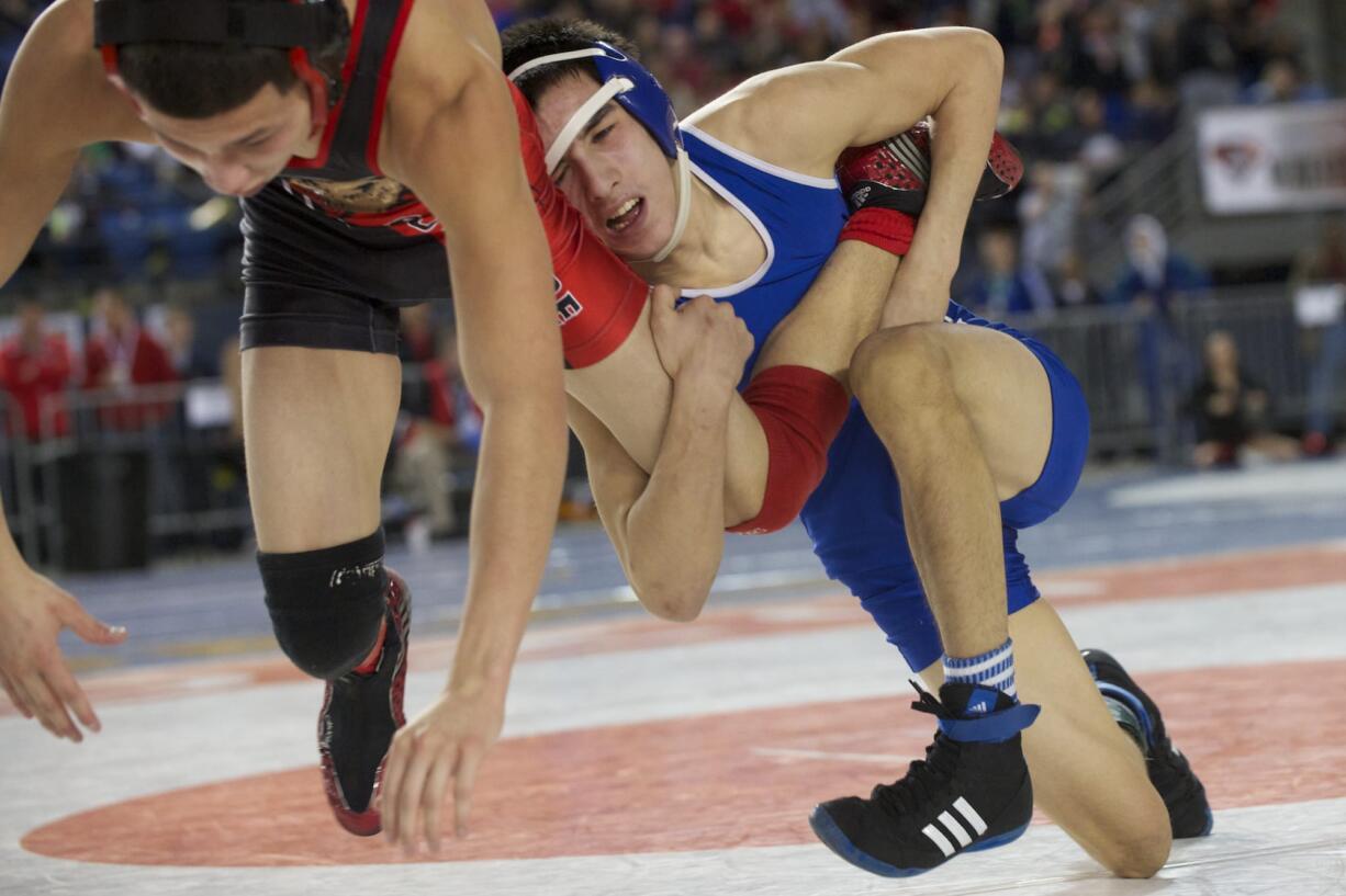 Mountain View 113-pounder Benjamin Dixon, in blue, was one of four Thunder wrestlers to win quarterfinal matches Friday.