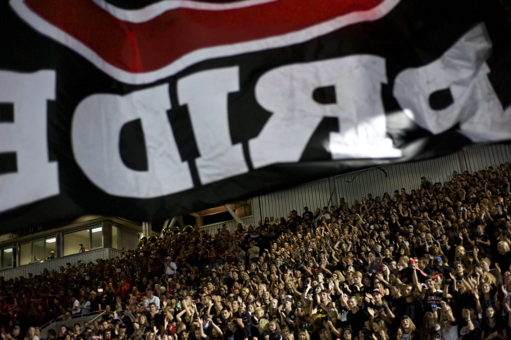 A Camas flag is run past the crowd in the first half of their game against Chiawana at Doc Harris Stadium on Friday September 5, 2014.