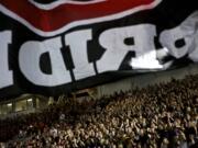 A Camas flag is run past the crowd in the first half of their game against Chiawana at Doc Harris Stadium on Friday September 5, 2014.