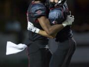 Zachary Kaufman/The Columbian
Jared Bentley, right, and James Price celebrate Bentley's scoring catch, the first Camas touchdown of the season.