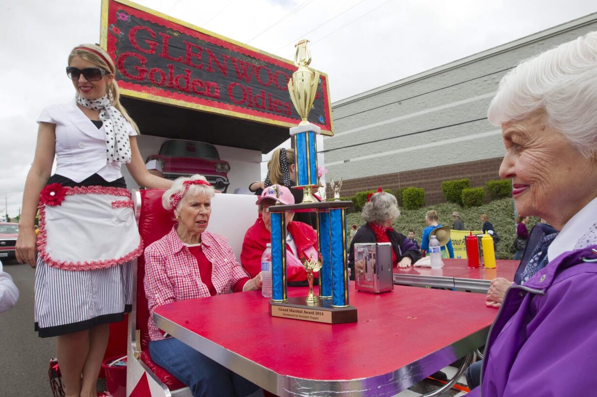 The Glenwood Golden Oldies float shows off their trophy Saturday at the 50th anniversary Hazel Dell Parade of Bands.