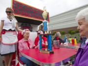 The Glenwood Golden Oldies float shows off their trophy Saturday at the 50th anniversary Hazel Dell Parade of Bands.