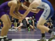 Union's Chase Wilson and Evergreen's Kristopher Walker, background, wrestle at 220 pounds as Heritage's Ebrahim Babajan and Skyview's Laycen Brown wrestle at 138 pounds in a pair of 4A GSHL dual matches at Heritage.