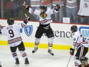 The Portland Winterhawks' Taylor Leier celebrates with teammates after scoring the game-winner in overtime against Kelowna in the WHL Western Conference Finals.