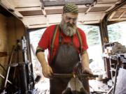 Blacksmith Nicholas Marcelja of Red Troll Forge, works from his shop, Thursday, August 14, 2014.