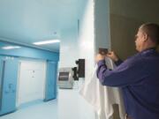 Clark County Jail Chief Ric Bishop demonstrates how a ball bearing is used in lieu of a hook to hold a towel inside a refurbished anti-suicide wing. The new area, dubbed A Pod 1, is scheduled to open in less than a month. Top: Clark County Jail Commander Kimberly Beltran gives a tour of a cell, which includes a platform that will be used as a bed.