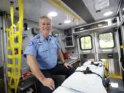 American Medical Response paramedic Rick Futrell sits inside an ambulance.