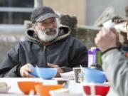 Joe Lukowiak, a homeless Vancouver man, eats and chats Sunday afternoon at the Stone Soup Community Meal in Turtle Place Park.