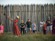 Eris Delay, 10, of Vancouver, plays with a ball while depicting a villager for the 1840's during the Campfires and Candlelight event at Fort Vancouver National Historic Site on Saturday September 14, 2013.