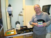 Ridgefield: Photography teacher Mark Cook shows off a homemade pinhole camera and his makeshift darkroom in an unused faculty restroom at Ridgefield High School.