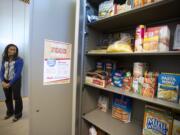 Kafiat Beckley, supervisor of the campus Cougar Center at Washington State University Vancouver, shows off the Cougar Food Pantry. She said the pantry got going when a financial aid system glitch in 2012 revealed just how needy some students were.