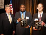 Rick Drake, from left, of the George C. Marshall Foundation, offers Vancouver High School senior Jose Scott the Marshall Youth Leadership Award and Matthew Bisturis the General George C.