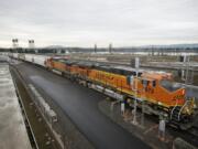 A BNSF Railway train moves grain along tracks adjacent to the city of Vancouver's waterfront site.