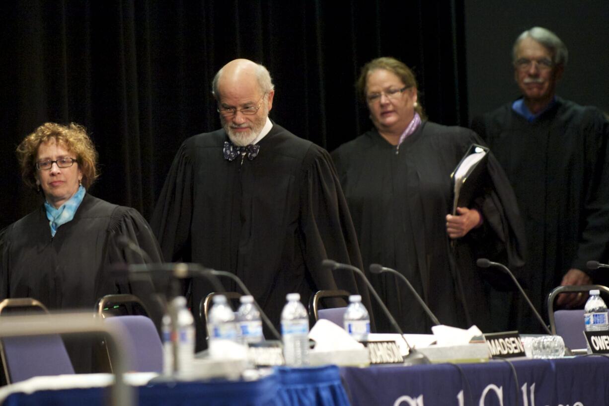 Washington Supreme Court justices, from left, Sheryl McCloud, Charles Wiggins, Mary Fairhurst and Charles Johnson enter Gaiser Hall to hear cases as part of their traveling court.