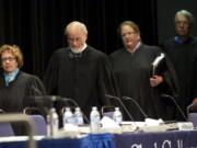 Washington Supreme Court justices, from left, Sheryl McCloud, Charles Wiggins, Mary Fairhurst and Charles Johnson enter Gaiser Hall to hear cases as part of their traveling court.