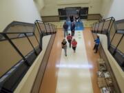 Sue Steinbrenner, director of facilities, left, and Bobbi Hite, principal of Crestline Elementary, tour the new school along with board members of Evergreen Public Schools on Thursday. The original school, which opened in 1973, was destroyed by an arson fire Feb.