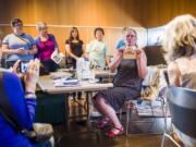 Marci Macfarlane explains how to make quilts from old t-shirts at the Vancouver Community Library Sunday during a workshop about how to repurpose vintage or used clothing into something more useful.