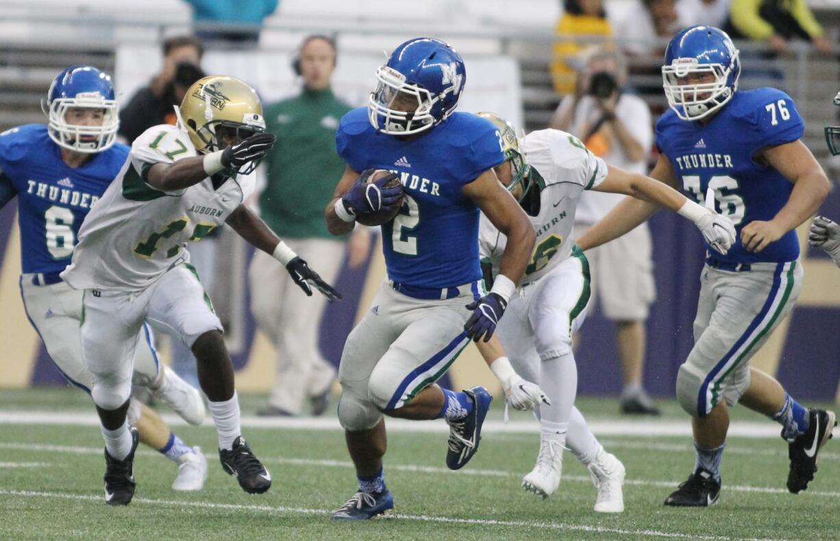 Mountain View running back Preston Jones (2) breaks tackles as the rushes for 120 yards on 18 carries against Auburn in  2015 Emerald City Kickoff Classic at Husky Stadium.  The Thunder beat the Trojans 32-2 .