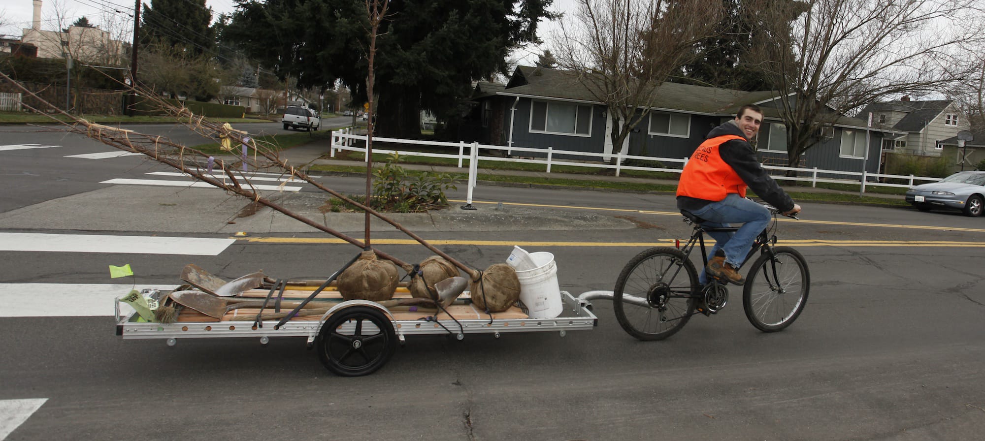 Josh Benjamin tows a load of soon-to-be-planted trees Saturday.