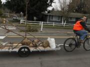 Josh Benjamin tows a load of soon-to-be-planted trees Saturday.