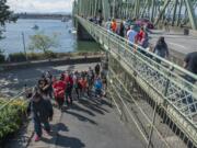 Participants in the Hands Across the Bridge event make their way onto the Interstate Bridge on Monday morning, Sept. 7, 2015.